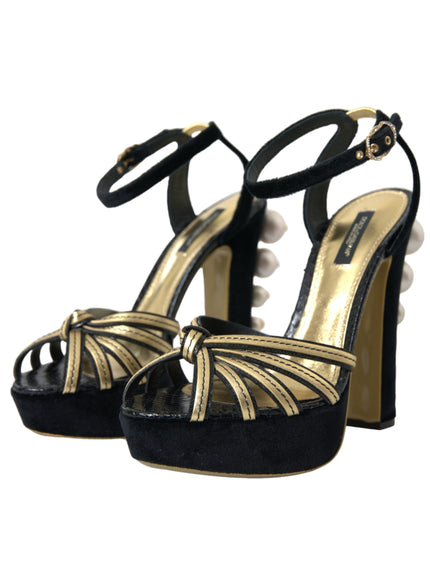 a pair of black and gold high heels