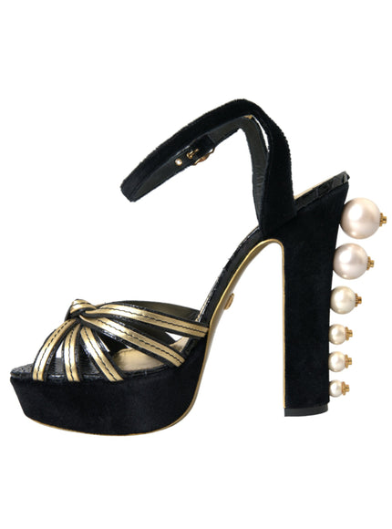 a black and gold high heeled shoe with pearls