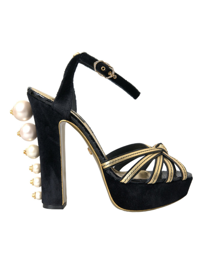 a black and gold high heeled shoe with pearls