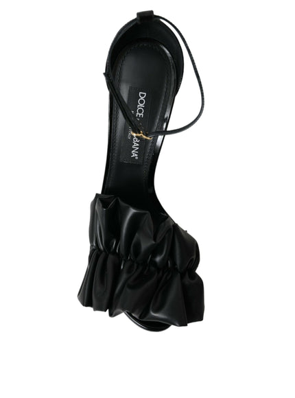 a black high heeled shoe with a ruffled heel