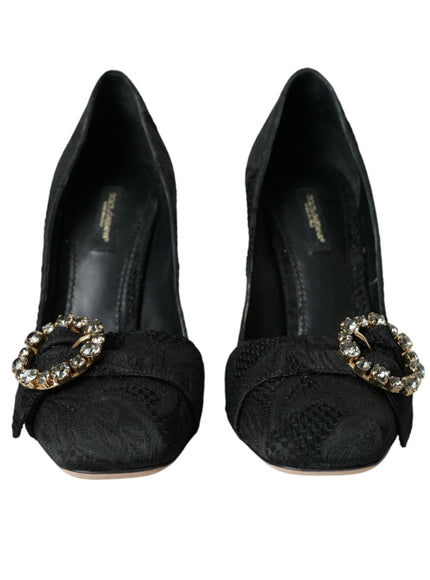 a pair of black shoes with a gold buckle