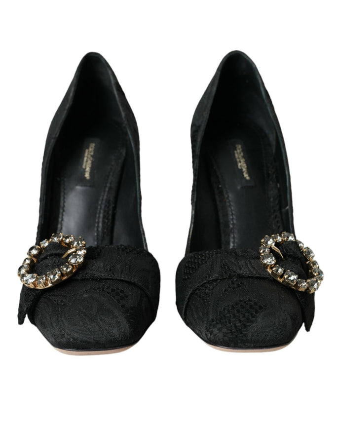 a pair of black shoes with a gold buckle