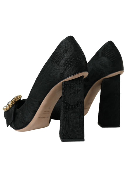 a pair of black high heels with a gold buckle