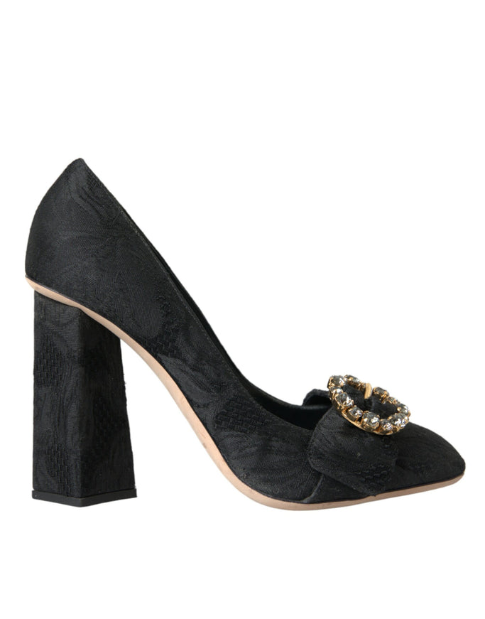 a pair of black high heels with a gold buckle