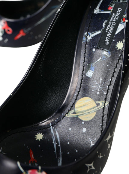 a pair of black high heels with saturn and stars on them