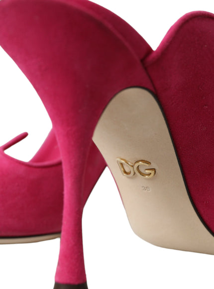 a pair of pink high heels with a gold logo