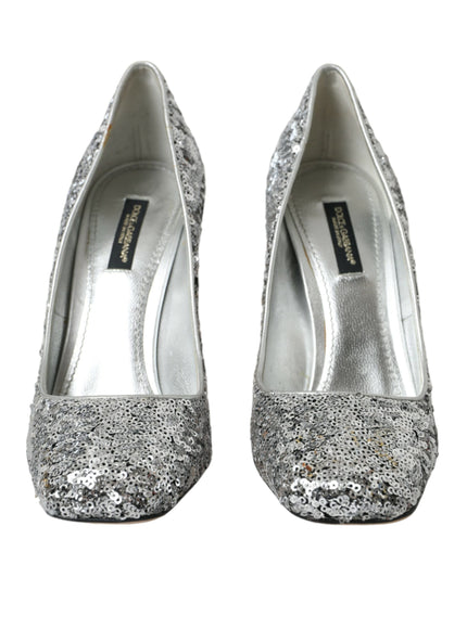 a pair of silver glitter shoes on a white background