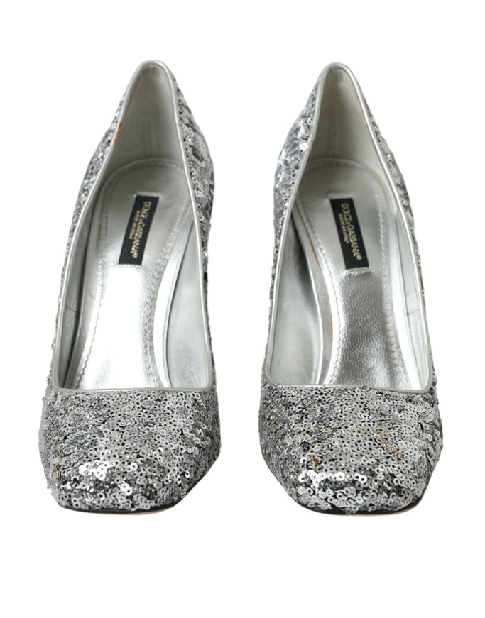 a pair of silver glitter shoes on a white background