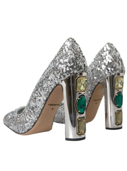 a pair of silver high heels with green stones