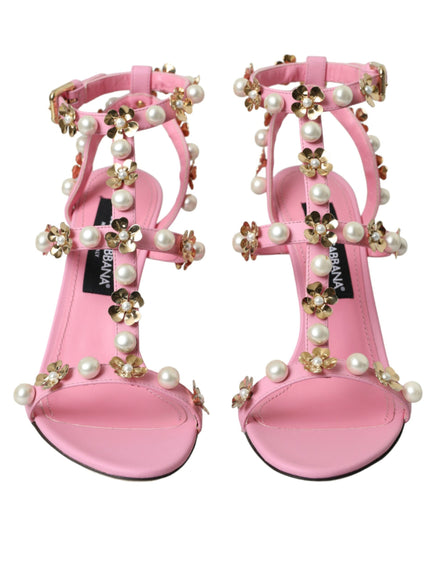 a pair of pink sandals with pearls on them