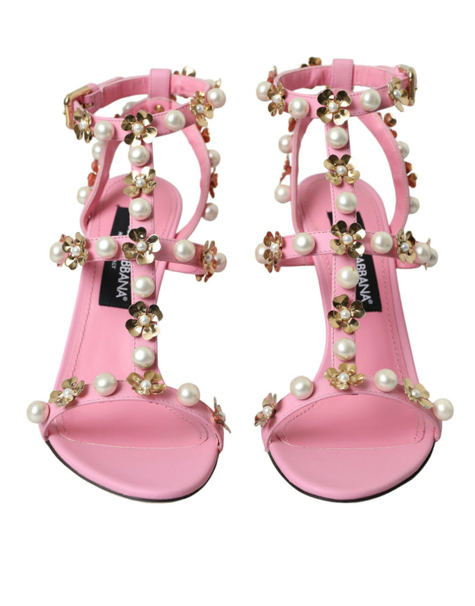 a pair of pink sandals with pearls on them