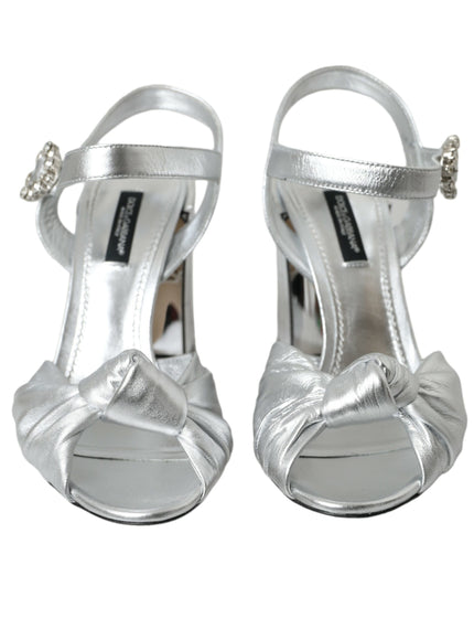 a pair of silver high heels with bows