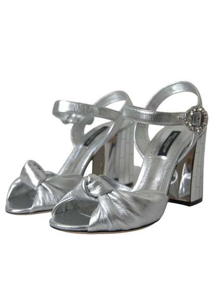 a pair of silver high heeled shoes on a white background