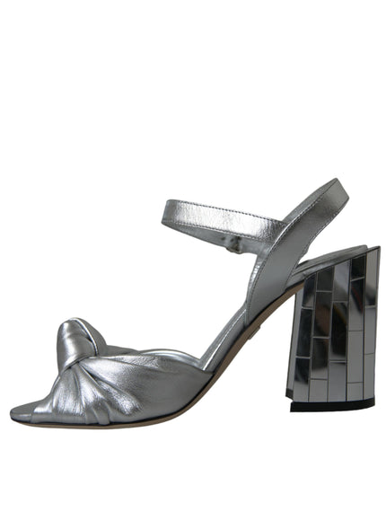 a pair of silver shoes on a white background