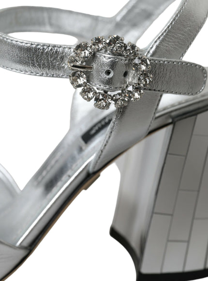 a woman's silver high heeled sandal with a jeweled buckle