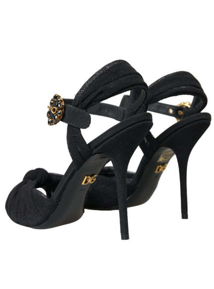 a pair of black high heels with a gold buckle