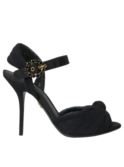 a black high heeled sandal with a gold buckle