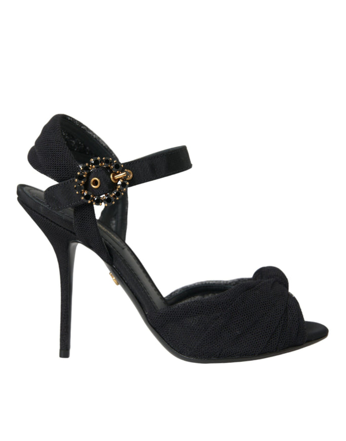 a black high heeled sandal with a gold buckle