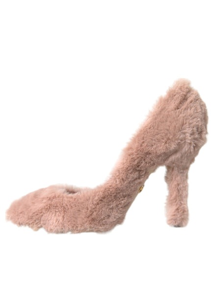 a pink furry high heeled shoe on a white background