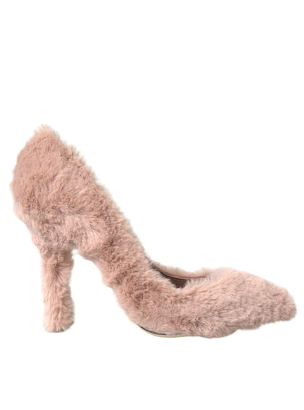 a woman's pink high heeled shoe with fuzzy fur