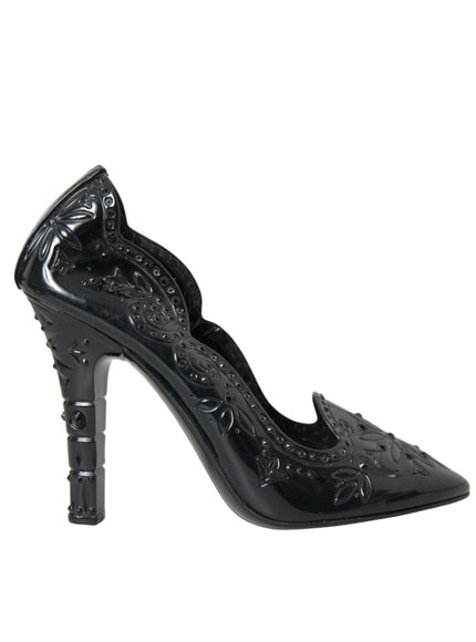 a woman's black high heeled shoe with an intricate design