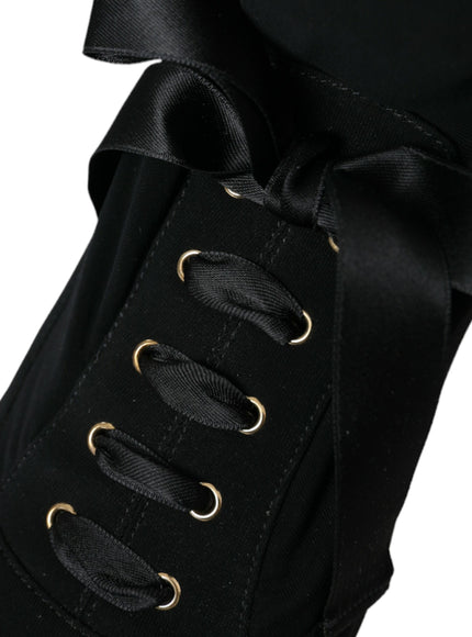 a close up of a black shoe with a bow