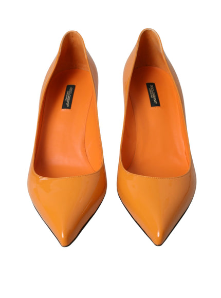 a pair of orange high heels on a white background