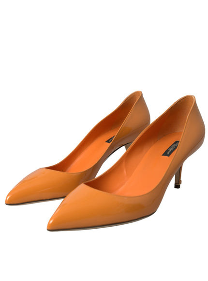 a pair of orange high heels on a white background