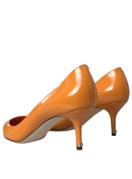 a pair of orange high heels on a white background