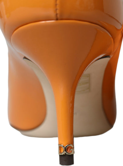 a close up of a pair of orange high heels