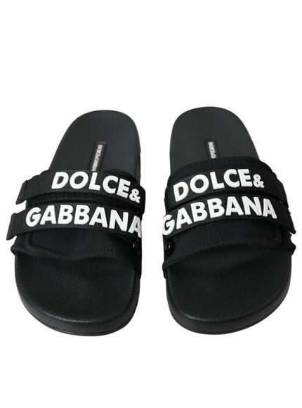 a pair of black sandals with white lettering