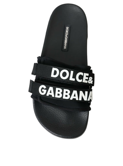 a pair of black sandals with white lettering