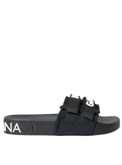 a black and white slider sandal with a logo on the side