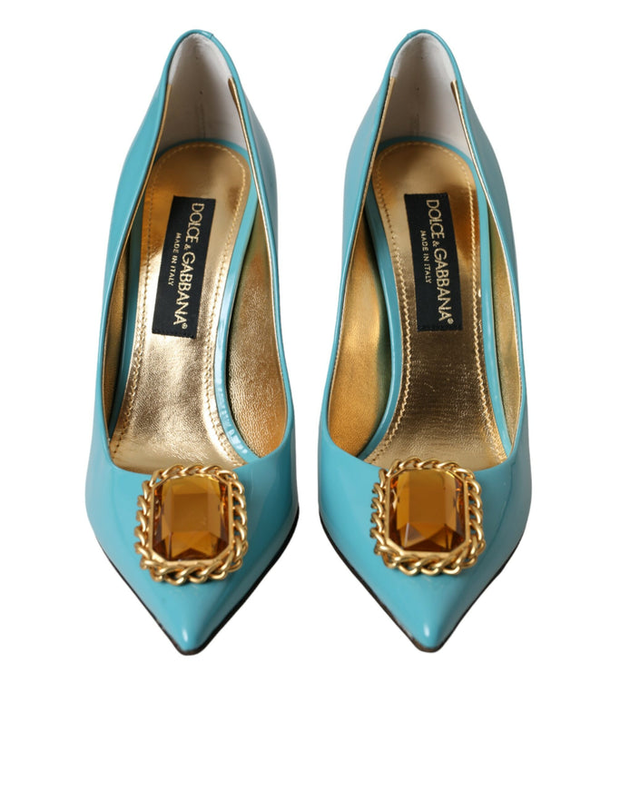 a pair of blue high heels with a gold buckle