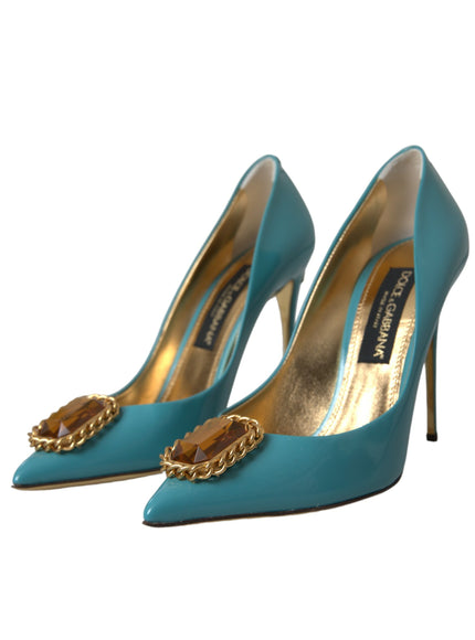 a pair of blue high heels with gold chains