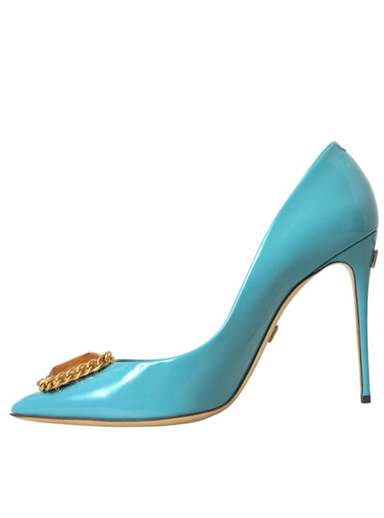 a blue high heeled shoe with a gold chain