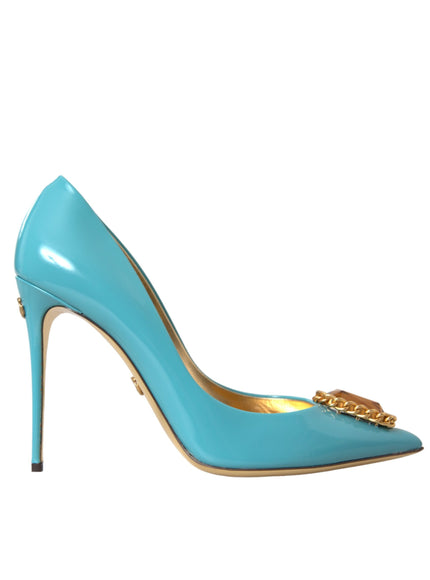 a blue high heeled shoe with a gold chain