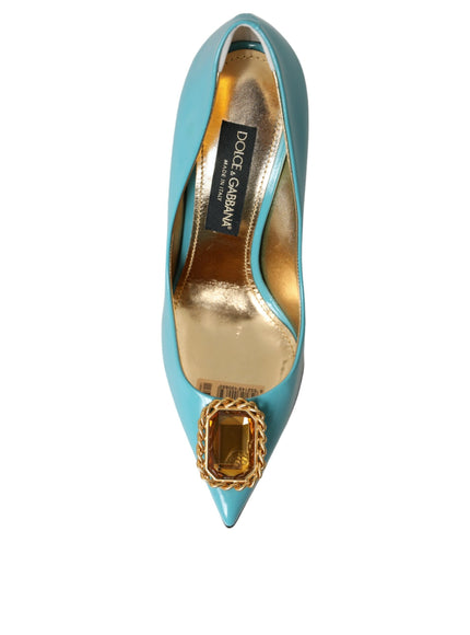 a blue high heel shoe with a gold buckle