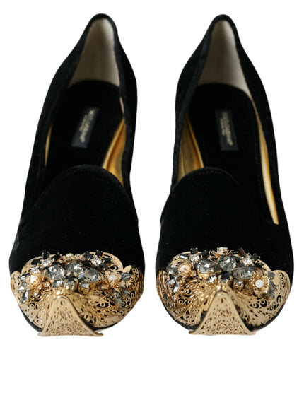 a pair of black shoes with a gold bow