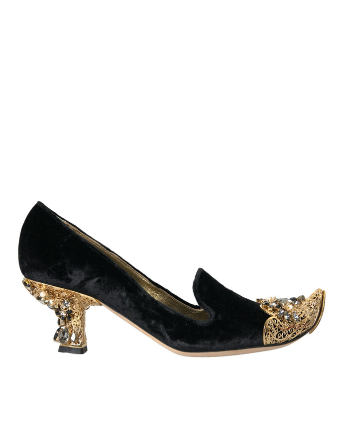 a pair of black and gold shoes on a white background