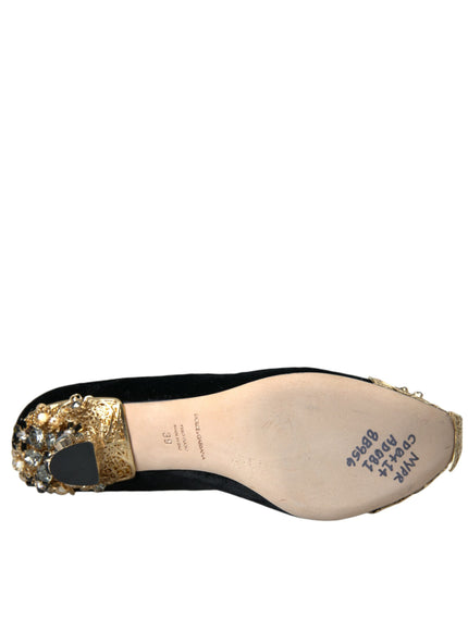 a pair of black and gold shoes on a white background