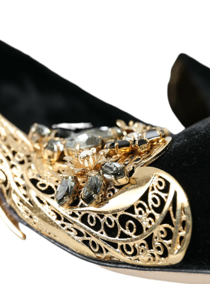 a close up of a pair of black shoes with gold accents