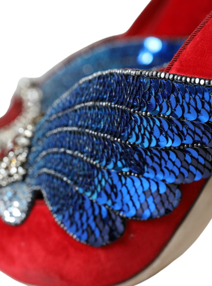 a pair of red shoes with blue feathers on them