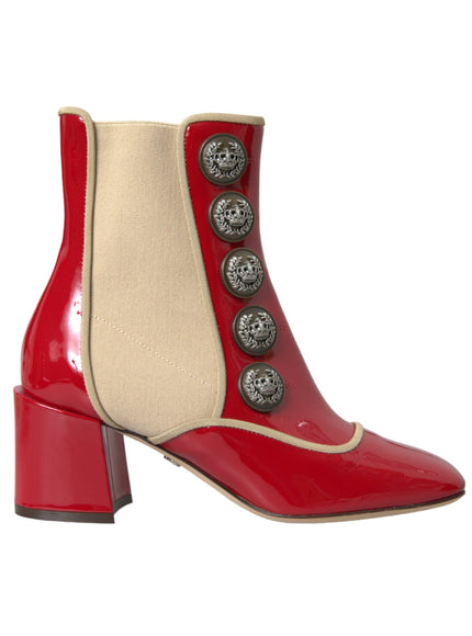 a pair of red and white boots with buttons