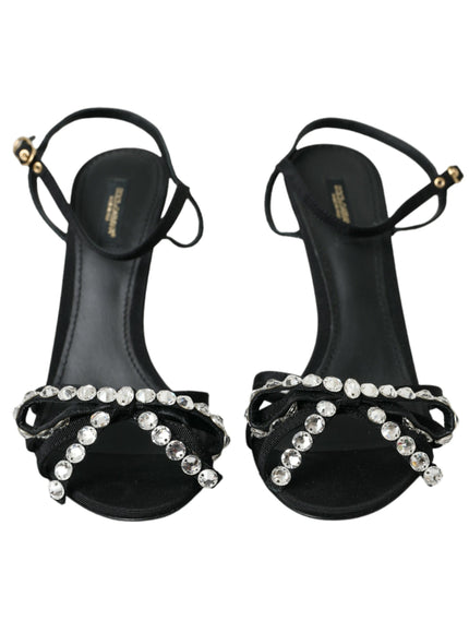 a pair of black sandals with a jewel embellishment