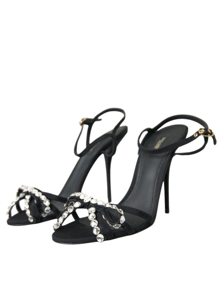 a black high heeled sandal with a jewel embellishment