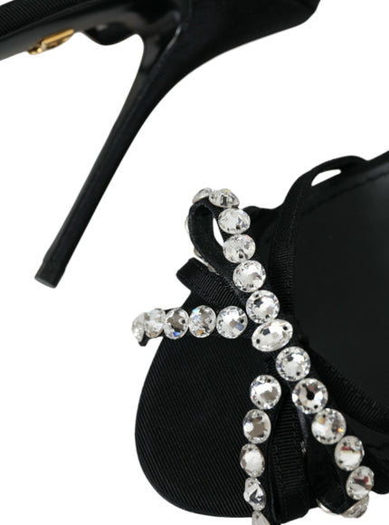 a pair of black shoes with crystal decorations on them