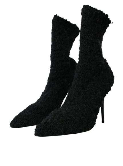 a pair of black high heeled shoes on a white background