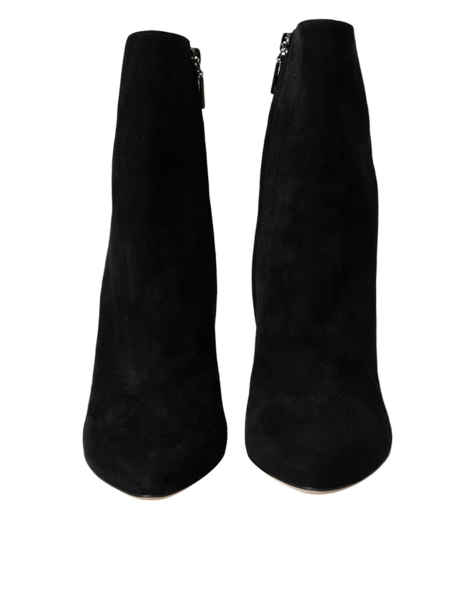 a pair of black boots with zippers