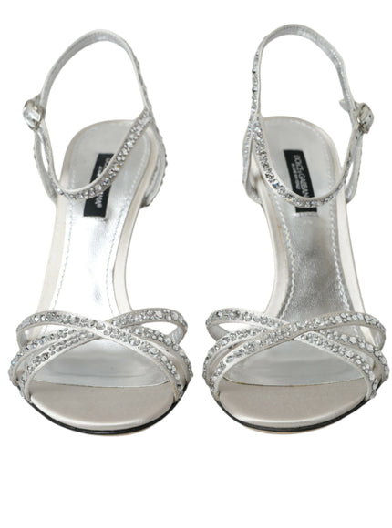 a pair of silver high heeled shoes on a white background